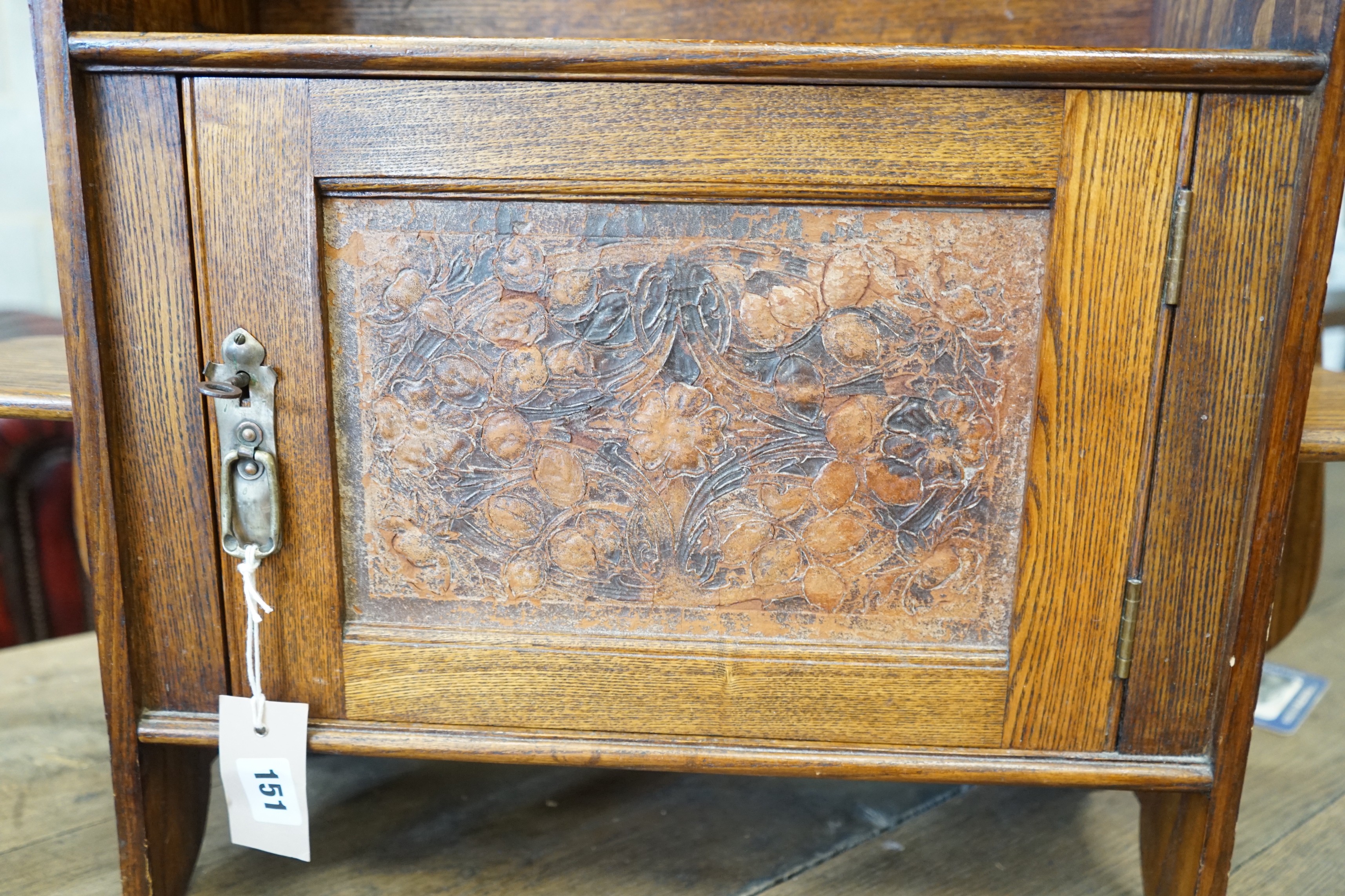 An Arts and Crafts oak wall cabinet, width 66cm, height 76cm